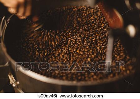 Man mixing roasted coffee beans View Large Photo Image Stock Image - Man mixing roasted coffee beans. Fotosearch