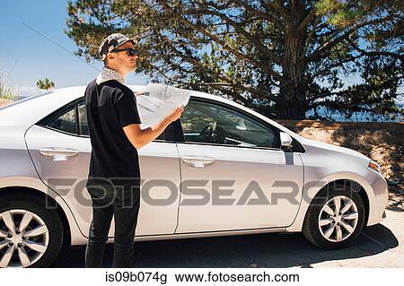 Man on road trip reading map, Big Sur, California, USA View Large Photo Image Stock Image - Man on road trip reading map, Big Sur, California, USA. Fotosearch