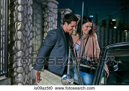 Man opening car door for young woman at night, Los Angeles, California, USA View Large Photo Image Stock Image - Man opening car door for young woman at night, Los Angeles, California, USA. Fotosearch