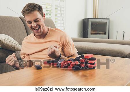 Man playing wooden block building game View Large Photo Image Stock Image - Man playing wooden block building game. Fotosearch