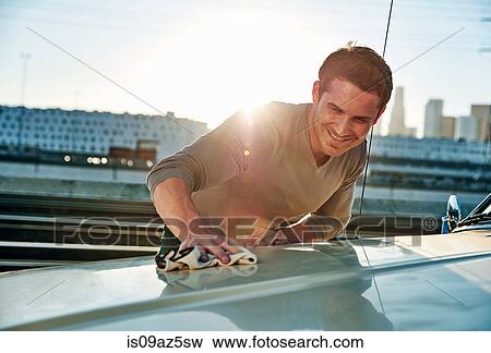 Man polishing car smiling, Los Angeles, California, USA View Large Photo Image Stock Photo - Man polishing car smiling, Los Angeles, California, USA. Fotosearch