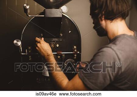 Man pouring coffee beans into coffee roaster, rear view View Large Photo Image Stock Image - Man pouring coffee beans into coffee roaster, rear view. Fotosearch