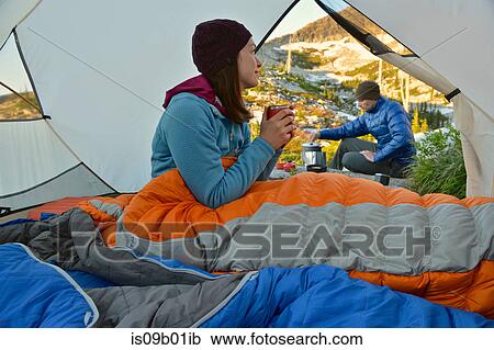 Man preparing breakfast for girlfriend in tent at Fault Lake, Selkirk Mountains, Idaho View Large Photo Image Stock Image - Man preparing breakfast for girlfriend in tent at Fault Lake, Selkirk Mountains, Idaho. Fotosearch