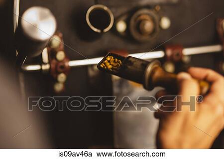 Man putting coffee beans into coffee roaster, close-up View Large Photo Image Stock Image - Man putting coffee beans into coffee roaster, close-up. Fotosearch