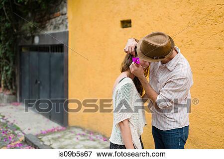 Man putting flower in woman's hair, Mexico City, Mexico View Large Photo Image Stock Photo - Man putting flower in woman's hair, Mexico City, Mexico. Fotosearch