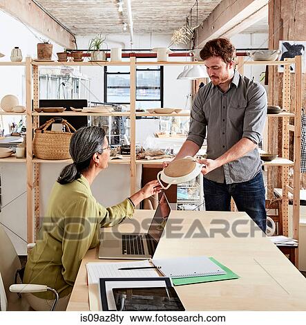Man showing colleague ceramic samples View Large Photo Image Stock Photo - Man showing colleague ceramic samples. Fotosearch