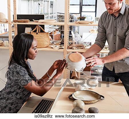 Man showing colleague ceramic samples View Large Photo Image Stock Photo - Man showing colleague ceramic samples. Fotosearch