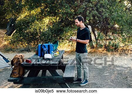 Man standing by picnic table, Malibu Canyon, California, USA View Large Photo Image Stock Photography - Man standing by picnic table, Malibu Canyon, California, USA. Fotosearch