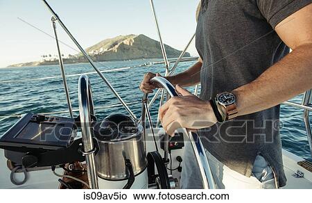 Man steering wheel of sailboat, San Diego Bay, California, USA View Large Photo Image Picture - Man steering wheel of sailboat, San Diego Bay, California, USA. Fotosearch