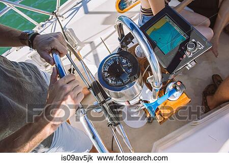 Man steering wheel of sailboat View Large Photo Image Stock Image - Man steering wheel of sailboat. Fotosearch