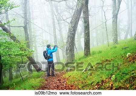 Man taking photograph while hiking in Shenandoah National Park, Virginia, USA View Large Photo Image Picture - Man taking photograph while hiking in Shenandoah National Park, Virginia, USA. Fotosearch