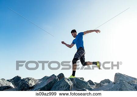 Man training, running on coast rocks, downtown San Diego, California, USA View Large Photo Image Stock Photo - Man training, running on coast rocks, downtown San Diego, California, USA. Fotosearch