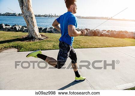 Man training, running on coast, downtown San Diego, California, USA View Large Photo Image Stock Photo - Man training, running on coast, downtown San Diego, California, USA. Fotosearch