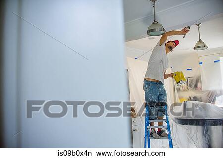 Man up stepladder painting ceiling View Large Photo Image Picture - Man up stepladder painting ceiling. Fotosearch