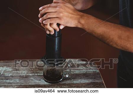 Man using aeropress coffee maker View Large Photo Image Picture - Man using aeropress coffee maker. Fotosearch