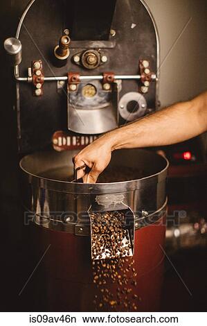 Man using coffee roaster View Large Photo Image Picture - Man using coffee roaster. Fotosearch
