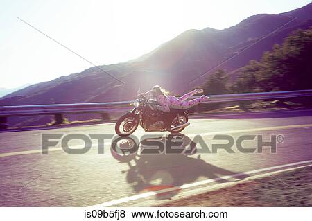 Man wearing pink onesie riding motorcycle, Malibu Canyon, California, USA View Large Photo Image Stock Photo - Man wearing pink onesie riding motorcycle, Malibu Canyon, California, USA. Fotosearch