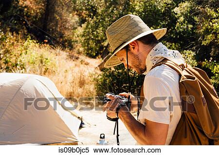 Man with camera by tent, Malibu Canyon, California, USA View Large Photo Image Stock Photography - Man with camera by tent, Malibu Canyon, California, USA. Fotosearch