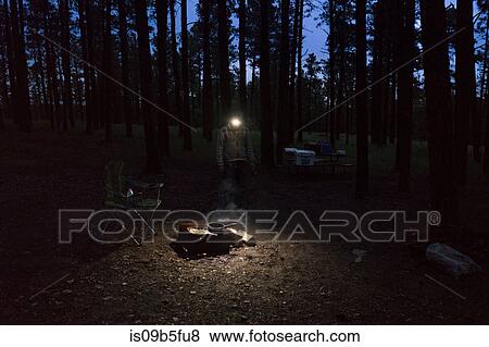 Man with headlamp cooking on campfire, South Dakota, USA View Large Photo Image Stock Photo - Man with headlamp cooking on campfire, South Dakota, USA. Fotosearch
