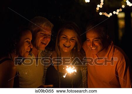 Mature adult couples playing with sparkler in garden at night View Large Photo Image Stock Photography - Mature adult couples playing with sparkler in garden at night. Fotosearch