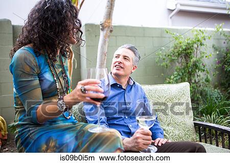 Mature couple chatting on patio at garden party View Large Photo Image Picture - Mature couple chatting on patio at garden party. Fotosearch
