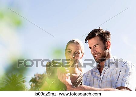 Mature couple inspecting plants in garden View Large Photo Image Stock Photo - Mature couple inspecting plants in garden. Fotosearch