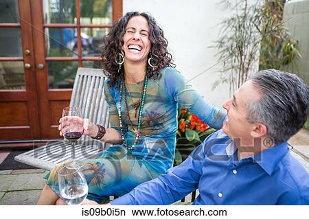 Mature couple laughing on patio at garden party View Large Photo Image Picture - Mature couple laughing on patio at garden party. Fotosearch