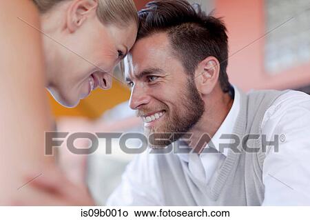 Mature couple touching heads, smiling View Large Photo Image Picture - Mature couple touching heads, smiling. Fotosearch