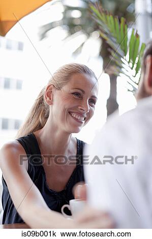 Mature man and woman at cafe, smiling View Large Photo Image Stock Image - Mature man and woman at cafe, smiling. Fotosearch