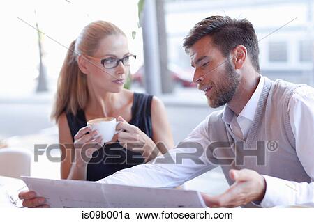 Mature man and woman, sitting outside cafe, having discussion View Large Photo Image Stock Image - Mature man and woman, sitting outside cafe, having discussion. Fotosearch