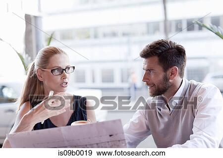 Mature man and woman, sitting outside cafe, having discussion View Large Photo Image Stock Photo - Mature man and woman, sitting outside cafe, having discussion. Fotosearch