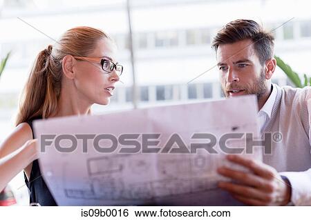 Mature man and woman, sitting outside cafe, looking at blueprints View Large Photo Image Stock Photograph - Mature man and woman, sitting outside cafe, looking at blueprints. Fotosearch