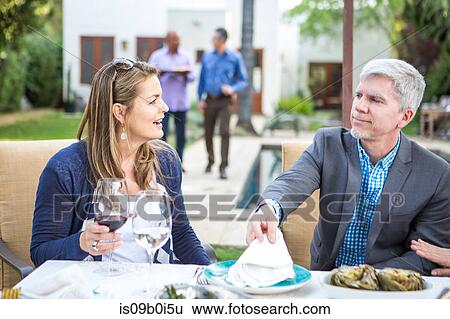 Mature man and woman talking at garden party table View Large Photo Image Stock Photograph - Mature man and woman talking at garden party table. Fotosearch