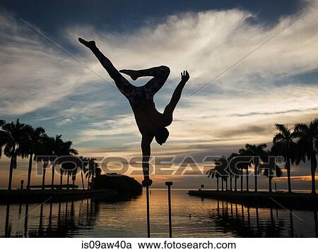 Mature man balancing on pole in water, dusk, South Pointe Park, South Beach, Miami, Florida, USA View Large Photo Image Stock Image - Mature man balancing on pole in water, dusk, South Pointe Park, South Beach, Miami, Florida, USA. Fotosearch