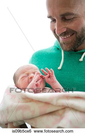 Mature man cradling newborn baby daughter View Large Photo Image Stock Photograph - Mature man cradling newborn baby daughter. Fotosearch