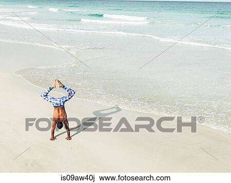 Mature man doing handstand on beach, South Pointe Park, South Beach, Miami, Florida, USA View Large Photo Image Stock Image - Mature man doing handstand on beach, South Pointe Park, South Beach, Miami, Florida, USA. Fotosearch