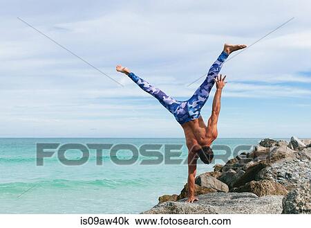 Mature man doing one handed handstand on rock, South Pointe Park, South Beach, Miami, Florida, USA View Large Photo Image Stock Image - Mature man doing one handed handstand on rock, South Pointe Park, South Beach, Miami, Florida, USA. Fotosearch