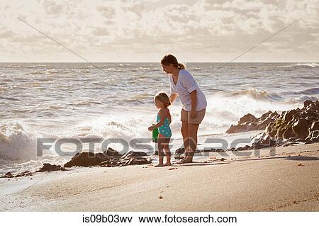 Mature woman and daughter watching splashing waves, Blowing Rocks Preserve, Jupiter Island, Florida, USA View Large Photo Image Stock Photo - Mature woman and daughter watching splashing waves, Blowing Rocks Preserve, Jupiter Island, Florida, USA. Fotosearch