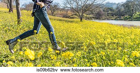 Mature woman running through field of wild flowers, low section, Paso Robles, California, USA View Large Photo Image Stock Photo - Mature woman running through field of wild flowers, low section, Paso Robles, California, USA. Fotosearch
