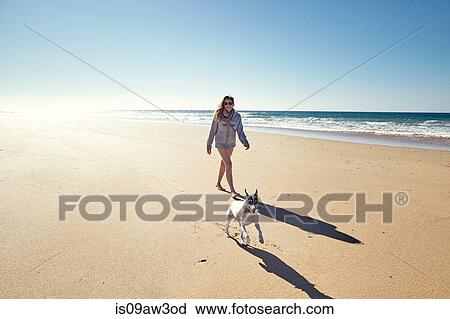 Mature woman with running dog on beach, Conil de la Frontera, Spain View Large Photo Image Stock Image - Mature woman with running dog on beach, Conil de la Frontera, Spain. Fotosearch