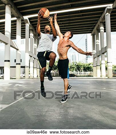 Men on basketball court jumping for basketball View Large Photo Image Stock Image - Men on basketball court jumping for basketball. Fotosearch