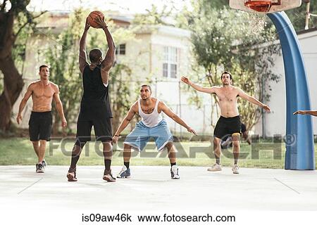 Men on basketball court playing basketball, defending hoop View Large Photo Image Stock Image - Men on basketball court playing basketball, defending hoop. Fotosearch