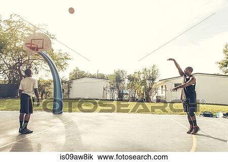 Men on basketball court scoring basketball hoops View Large Photo Image Stock Image - Men on basketball court scoring basketball hoops. Fotosearch