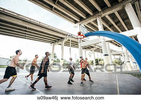 Men on basketball court watching basketball go through hoop View Large Photo Image Stock Image - Men on basketball court watching basketball go through hoop. Fotosearch