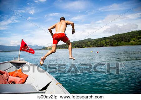 Mid adult man jumping into sea from boat, Nehalem Bay, Oregon, USA View Large Photo Image Stock Photography - Mid adult man jumping into sea from boat, Nehalem Bay, Oregon, USA. Fotosearch