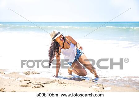 Picture - Mid adult woman falling on beach, Malibu, California, USA. Fotosearch