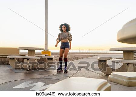 Mid adult woman on rollerskates, near beach View Large Photo Image Stock Photo - Mid adult woman on rollerskates, near beach. Fotosearch