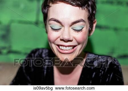 Mid adult woman with green eye-shadow, smiling View Large Photo Image Stock Image - Mid adult woman with green eye-shadow, smiling. Fotosearch