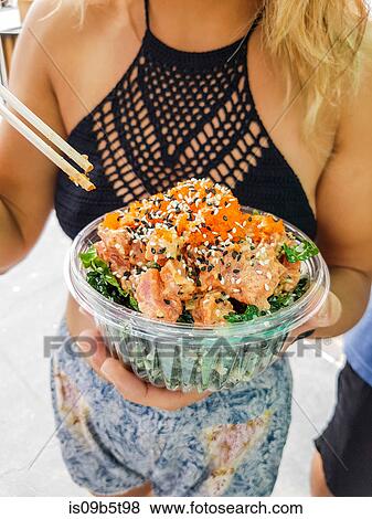 Mid section of young woman eating poke bowl at Hermosa Beach, California, USA View Large Photo Image Stock Photo - Mid section of young woman eating poke bowl at Hermosa Beach, California, USA. Fotosearch