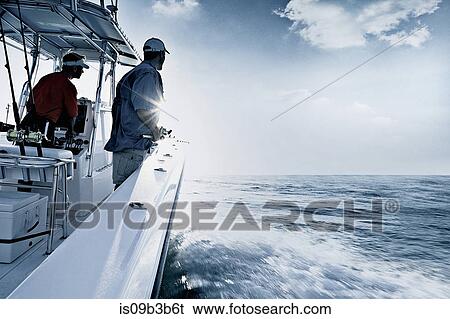 Monochromatic shot of two men driving and fishing from speedboat, Miami, USA View Large Photo Image Stock Photograph - Monochromatic shot of two men driving and fishing from speedboat, Miami, USA. Fotosearch